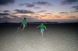 playing on the beach at sunset