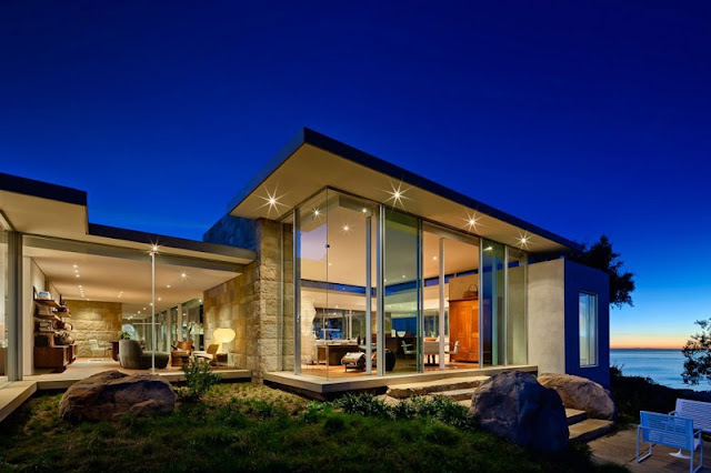 Night View of the Home with Wide Glass Walls and the Bright Lighting