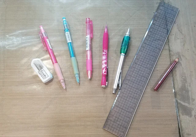 White Stroke eraser, Color Eno (Pink), Color Eno (Soft Blue), Mono Knock Eraser, Pentel Icy (HB lead), Pentel Graph Gear 1000 (B lead) Clear, gridded acrylic ruler, Prismacolor Color Pencil