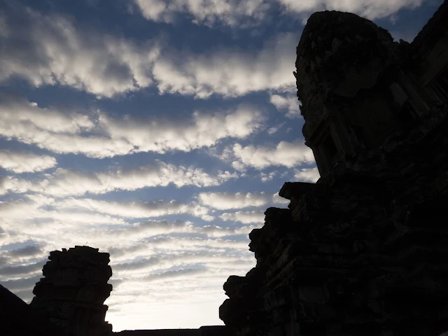 puffy white clouds just after sunrise over Angkor Wat in Cambodia