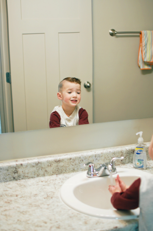 Little boy smiles after potty training success.