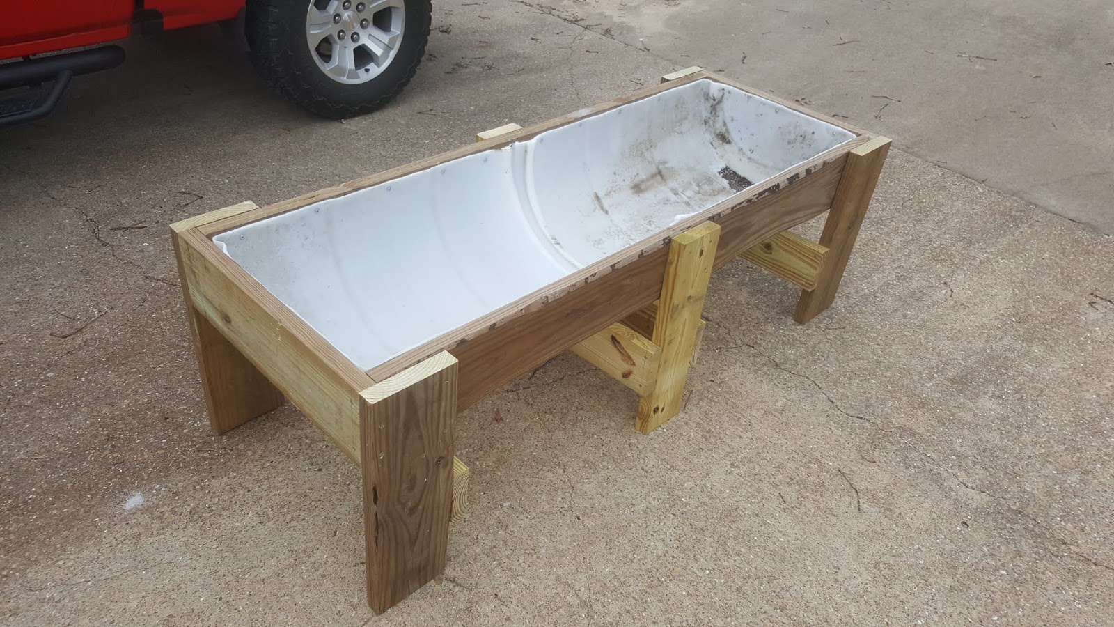 Texas Woodsman Cattle Feed Trough Made from Extra Wood & a Plastic Barrel