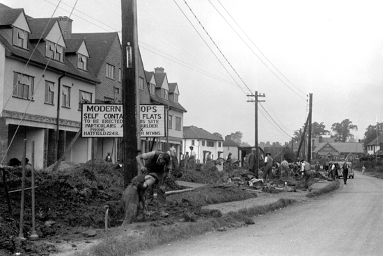 Photograph of the shops in Dellsome Lane, Welham Green being built in 1936/7. Image from Mill Green Museum