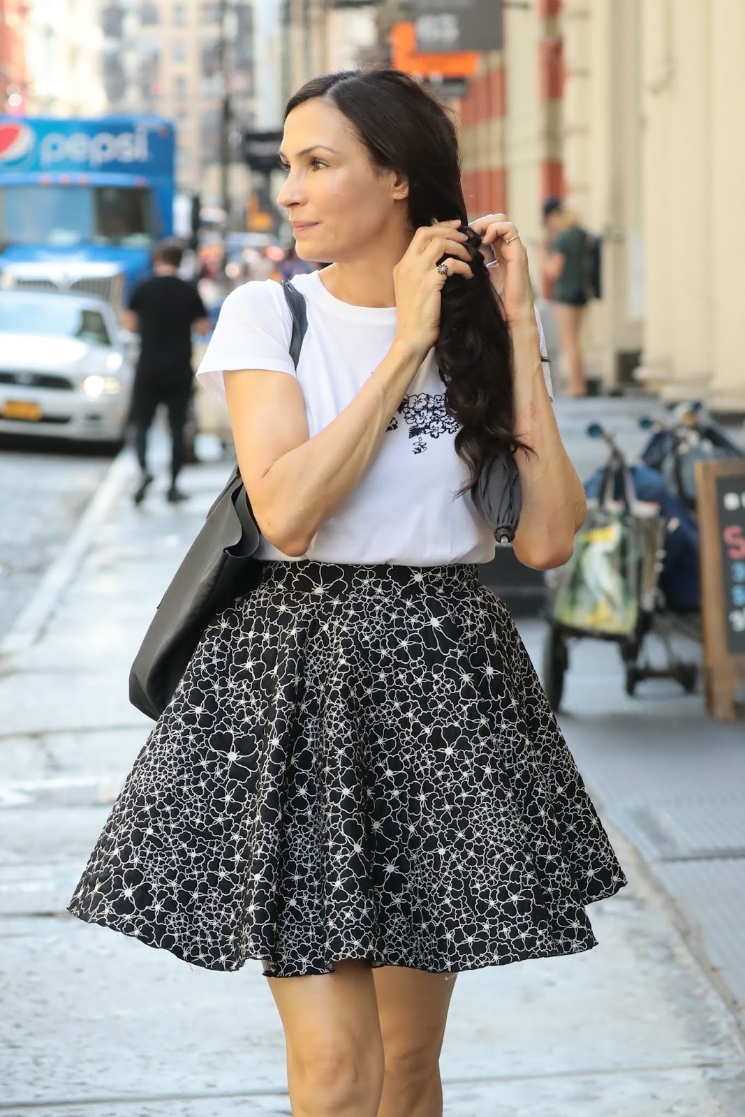 Famke Janssen plays with her hair during a stroll through SoHo 07/31