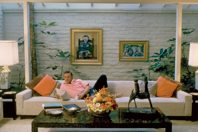Kirk Douglas stretches out on a skylit sofa in his Beverly Hills home in the early 1960s