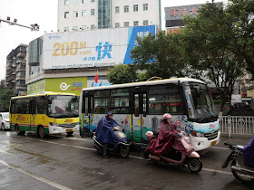 two mid-sized Jumbo Wuzhou Buses