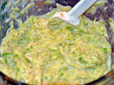 Crispy zucchini fritters mash being mixed in a bowl