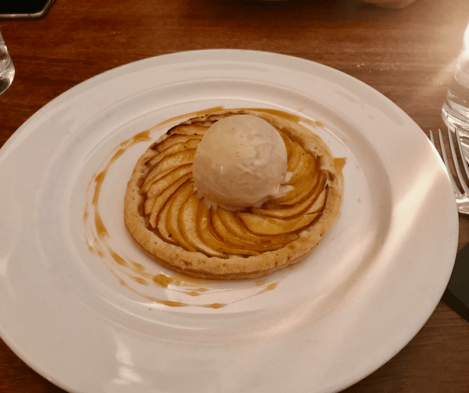 apple tart with scoop of ice-cream on a white plate