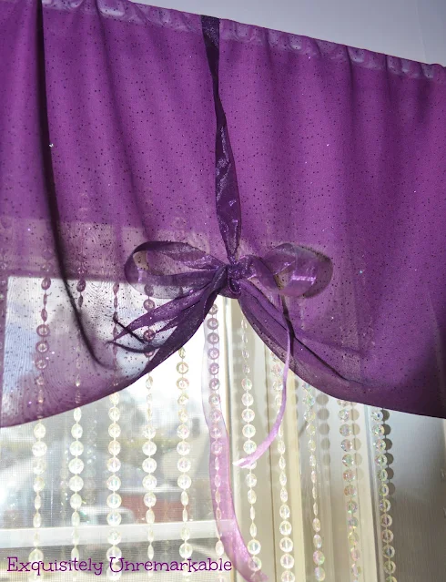 Easy Ribbon Valance in purple sheer fabric over beads on window