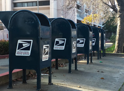 Mailboxes 5 U.S. Postal mailboxes aligned in a row on a drive-by sidewalk