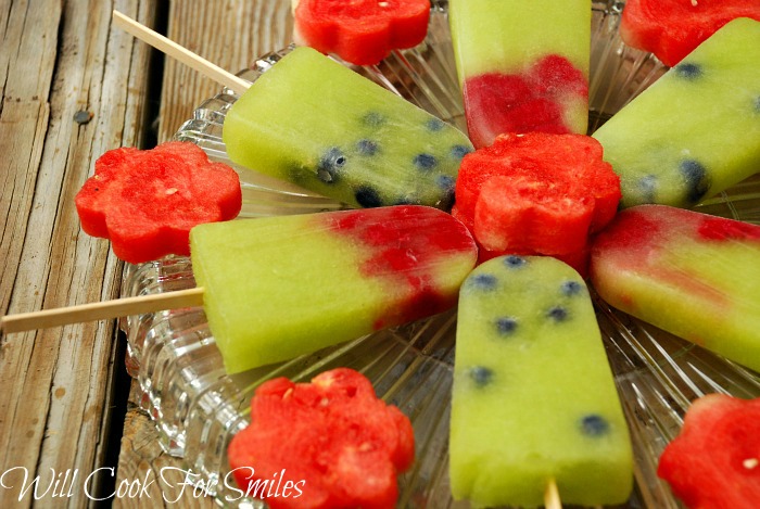 Honeydew Melon Berry ice Pops with watermelon flowers between them on a glass platter 