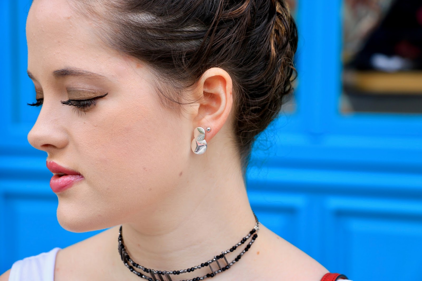fashion blogger wearing silver earrings and choker
