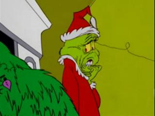 The Grinch sawing Max's antlers in How the Grinch Stole Christmas movieloversreviews.filminspector.com