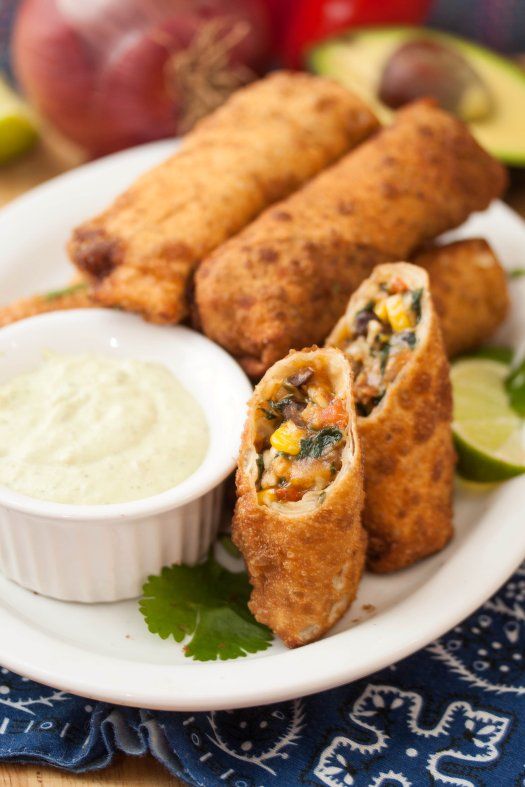 With Super Bowl upon us tomorrow, I thought it was only prudent to share a great appetizer recipe with you before the big game! I’ve wanted to make these guys for a couple years now, but just never managed to get around to it. Traditional homemade egg rolls are one of our very favorite things ever, and we love Mexican food – so it was totally no surprise when we all loved them! Corn, red pepper, black beans, red onion, spinach, garlic, and cilantro are given a quick saute to soften. 