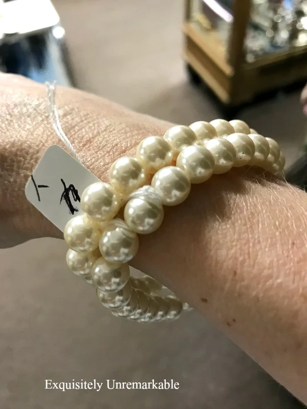 Pearl Bracelets on a wrist with a $4 price tag