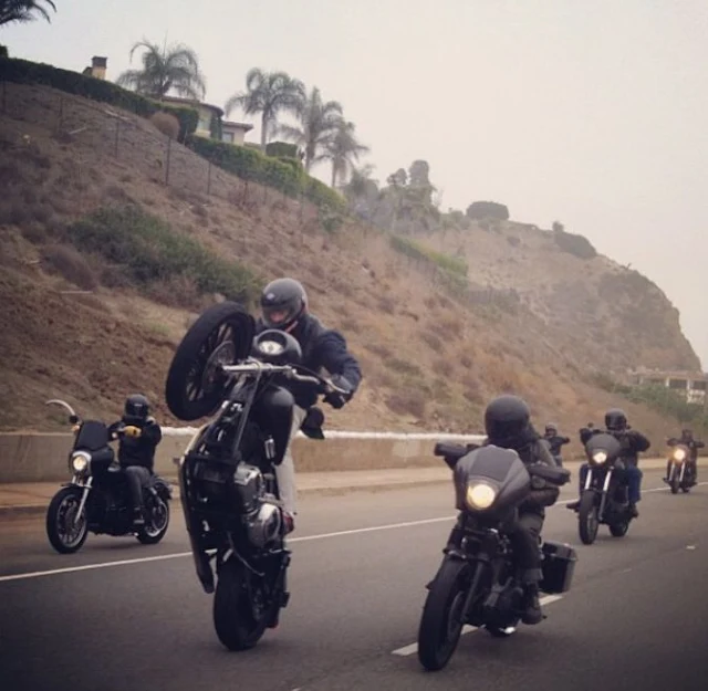 Matte black Harley Davidson Dyna wheelie.