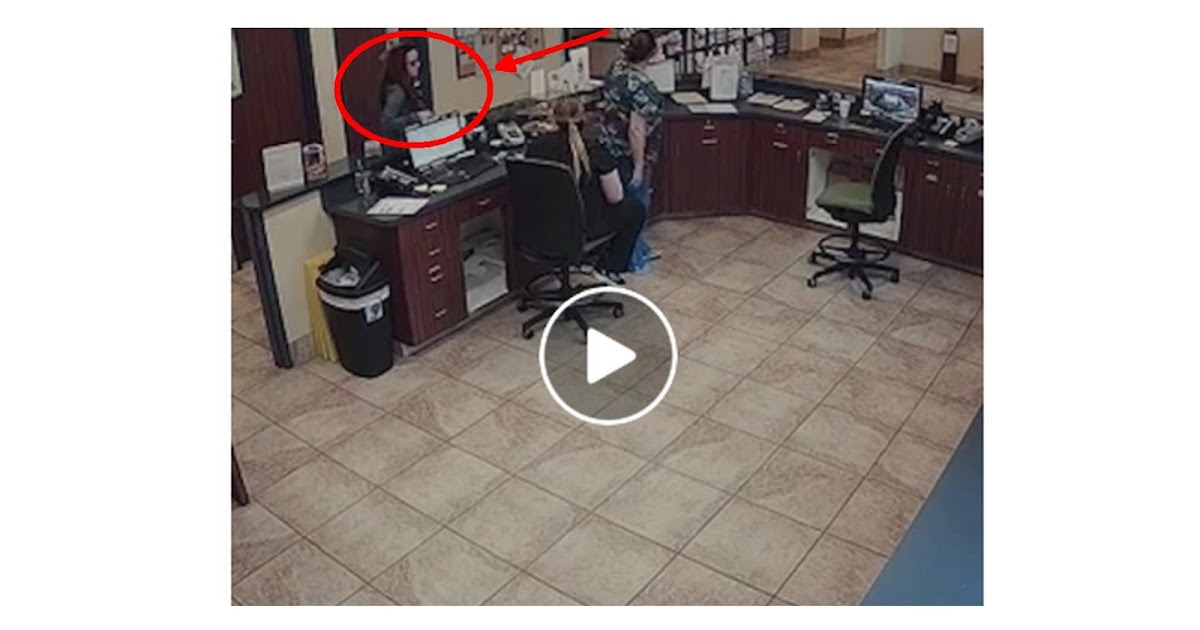 A shaking woman secretly slips a handwritten note to a veterinarian