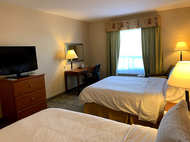 a room with two beds and a tv