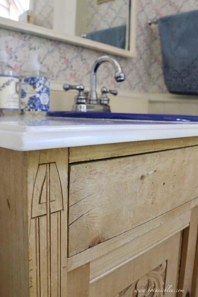 Budget wise cultured marble countertop with ogee edges and a porcelain sink in a vintage pine washstand