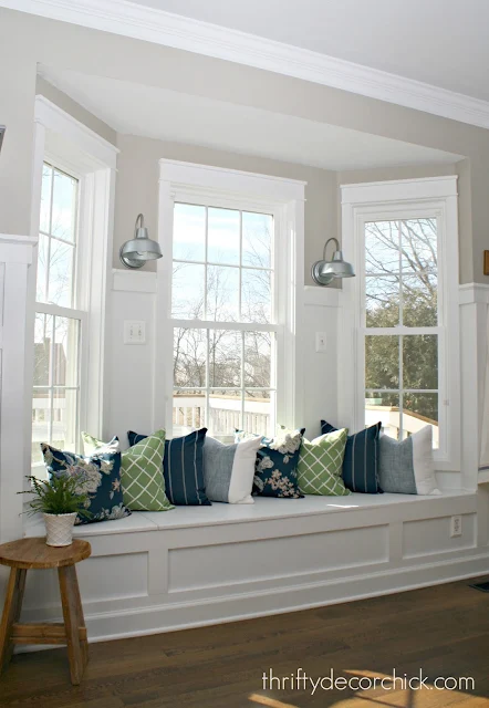 Kitchen window seat with pillows and sconces