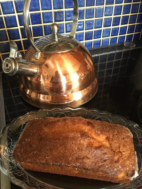 copper whistling kettle and lemon drizzle cake