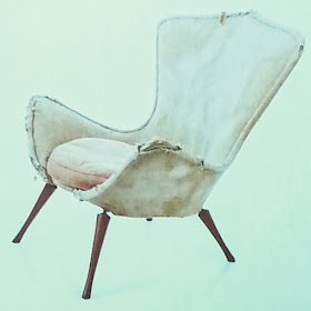 Slide of a battered Grant Featherston E51 chair.