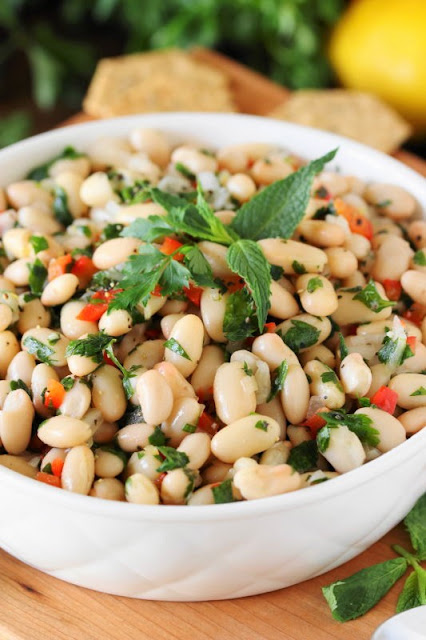 Lemony White Bean Salad ~ Serve up this flavor-packed salad as a side, or pair it with crackers for a a totally tasty dip.  It's perfect for healthier snacking & eating!  www.thekitchenismyplayground.com