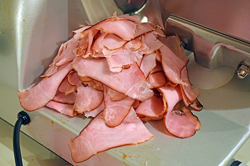 Ham sliced thinly on a Beswood 250 meat slicer.