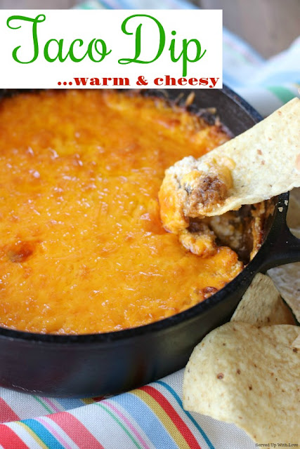 Warm and cheesy Taco Dip is the perfect dip recipe to serve a crowd. Your guests won't be able to stop eating it. 