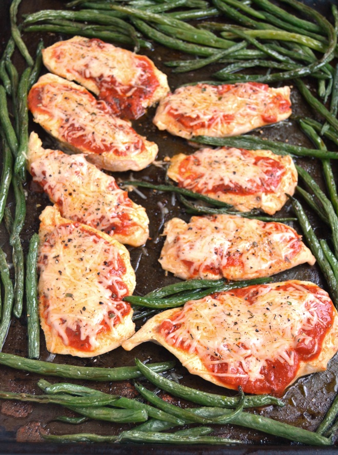 5-Ingredient Baked Chicken Parmesan cooks on a sheet pan and skips the breading and frying for a healthier meal! Loaded with your favorite tomato sauce and melted Parmesan and mozzarella cheeses. www.nutritionistreviews.com