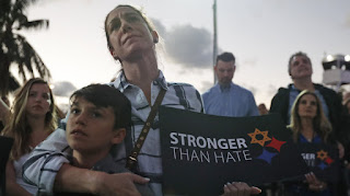 Taly Kogon and her son Leo, 10, listen to speakers during an interfaith vigil against anti-Semitism and hate at the Holocaust Memorial late last month in Miami Beach, Fla.