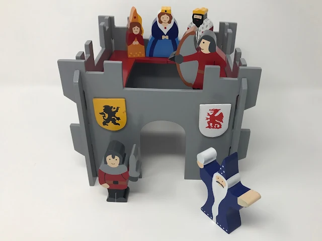 The Wooden castle set on a white background showing the front and top of the castle and the characters