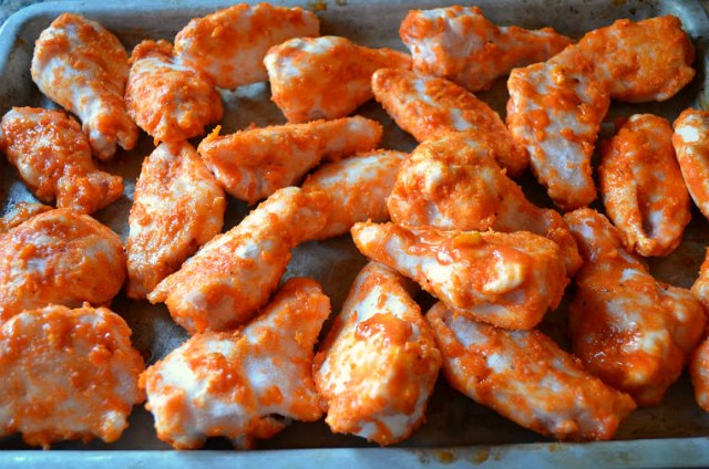 Baked Chicken Hot Wings spread on baking sheet going in the oven from Serena Bakes Simply From Scratch.