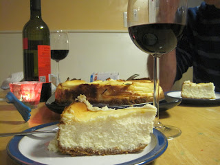 Cheesecake, sliced, and glass of wine