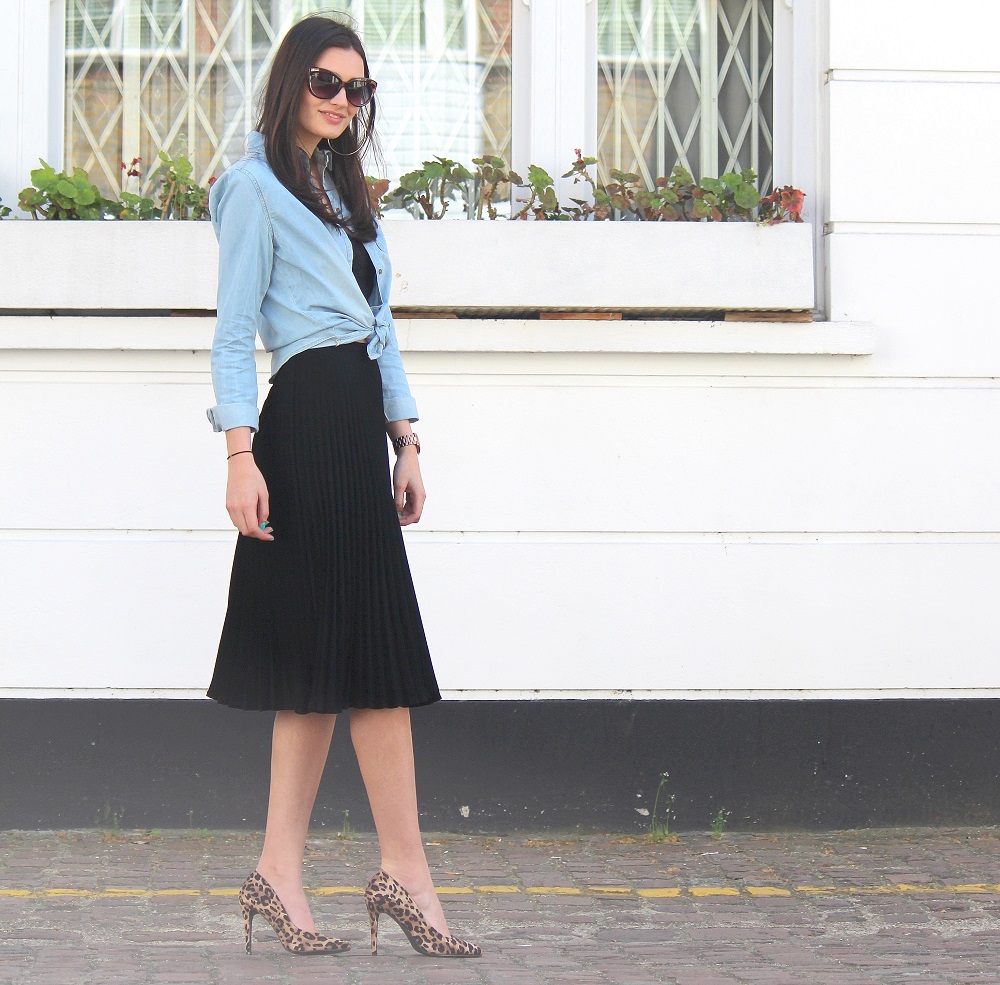 peexo fashion blogger wearing pleated midi skirt with lace bralet and denim shirt and leopard print heels and sunglasses in spring