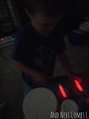 Drumming with glow sticks from And Next Comes L