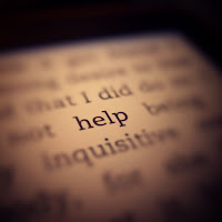 abstract photo of a dictionary.  the word help is highlighted.