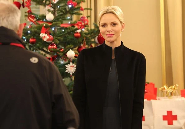 Princess Charlene wore Akris jumpsuit and Akris coat at Monaco Red Cross for Christmas gifts. Christian Dior erarrings