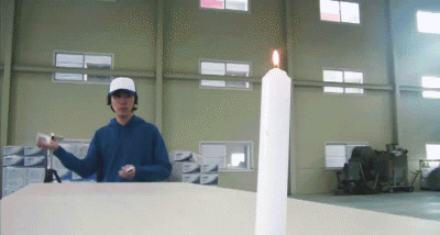 throwing card at candle