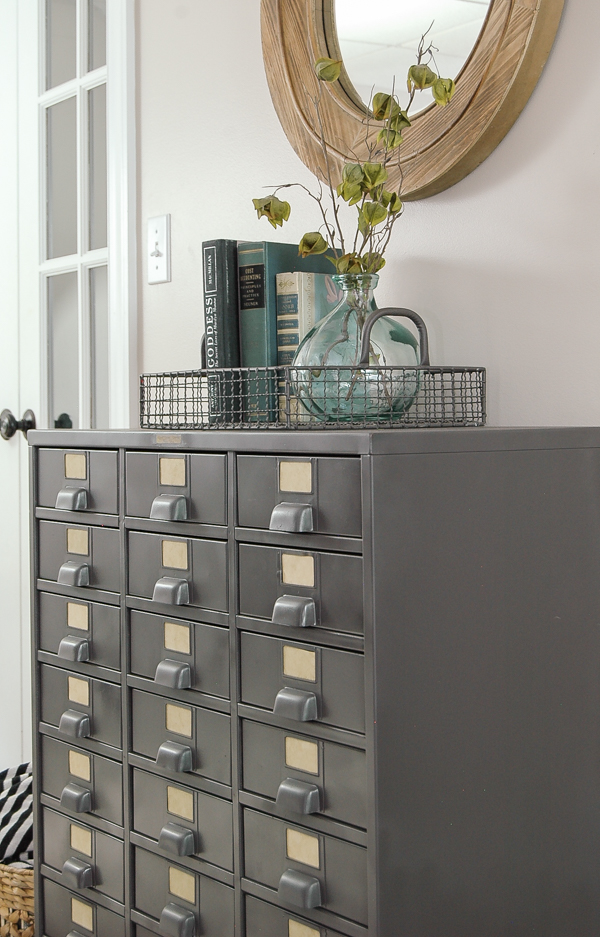 I LOVE this piece!  A vintage metal hardware cabinet gets restored and turned into perfect home storage. www.littlehouseoffour.com