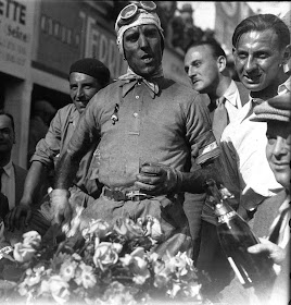 A garlanded Nuvolari after winning the  French Grand Prix in 1932