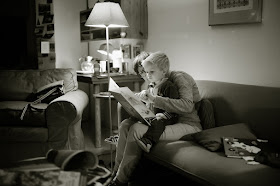Son sitting on his mother's lap, both of them reading
