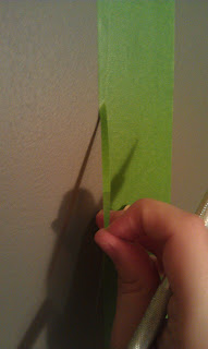 taping and using knife to cut trees for painting diy wall art mural
