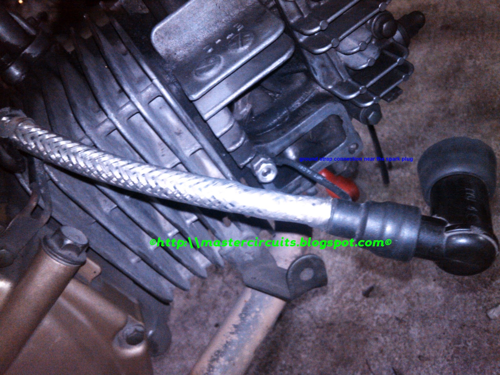 Ignition coil bolted to its mounting bracket together with the modded ignition wire ground strap together.