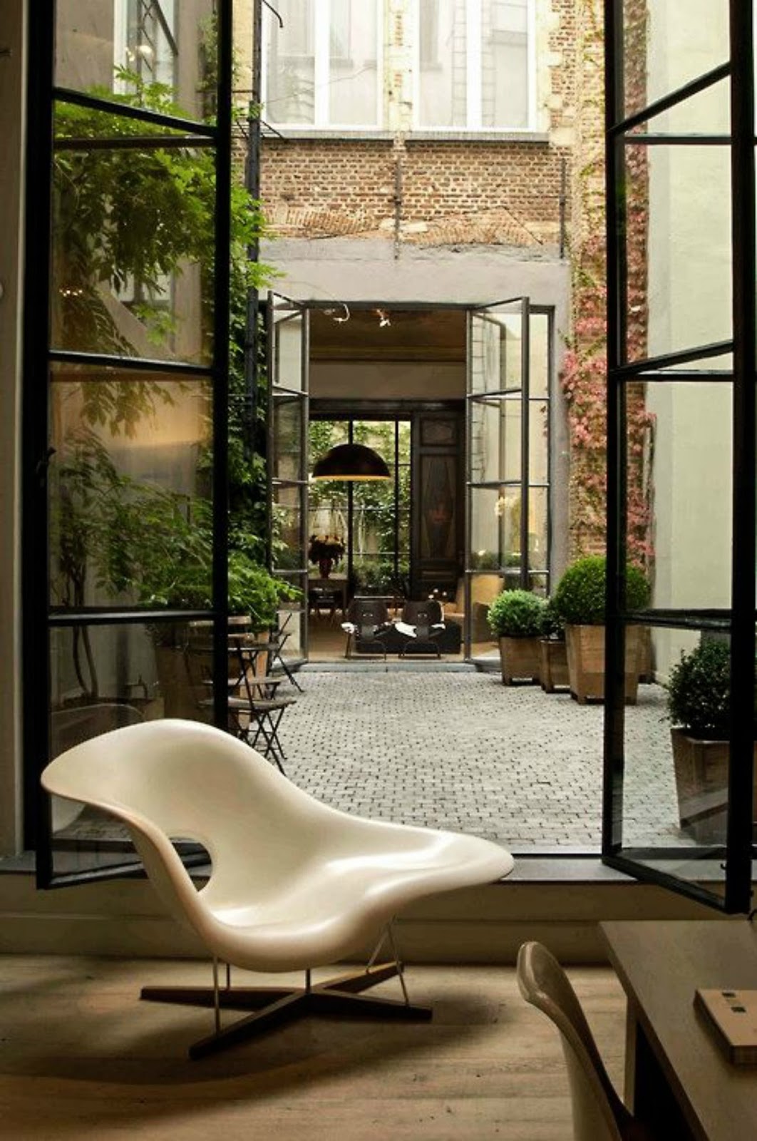 modern minimal black french doors stone patio design