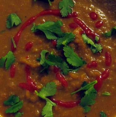 carrot soup with bean broth and cilantro sriracha garnish