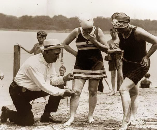 40 Must-See Photos Of The Past - Measuring bathing suits – if they were too short, women would be fined, 1920′s