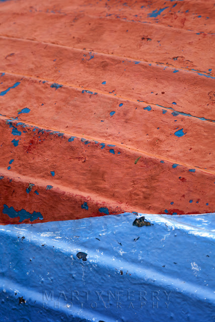 Vibrant colours on an old boat at Holy Island, Northumberland by Martyn Ferry Photography