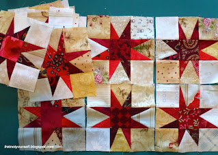 Quilt blocks where the red star points have various lengths.