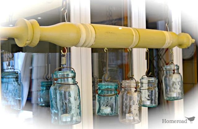 Green post with hanging blue and clear Mason Jars